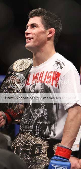 Dominick Cruz with UFC and WEC championship belts (Scott Petersen & MMA Weekly)